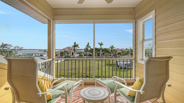 sunroom / solarium featuring ceiling fan and plenty of natural light