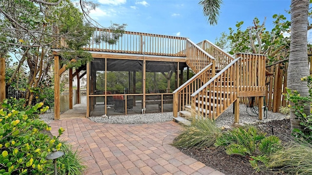 view of patio featuring a sunroom