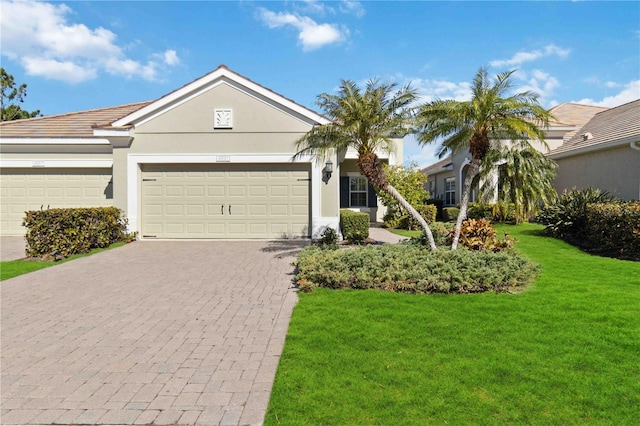 ranch-style house featuring a garage and a front yard