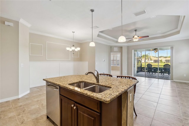 4891 Maymont Park Cir, Bradenton, FL 34203 - kitchen with sink, light stone counters, stainless steel dishwasher, a tray ceiling, and an island with sink