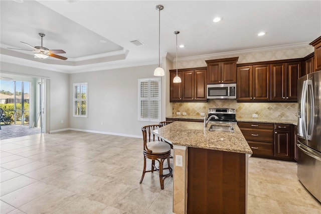 4891 Maymont Park Cir, Bradenton, FL 34203 - kitchen featuring pendant lighting, crown molding, stainless steel appliances, and an island with sink