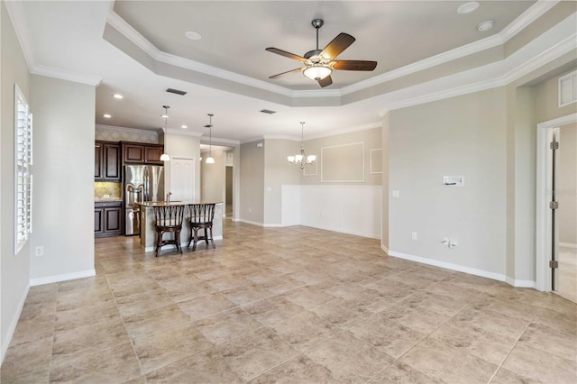 4891 Maymont Park Cir, Bradenton, FL 34203 - unfurnished living room featuring a raised ceiling, crown molding, and ceiling fan with notable chandelier