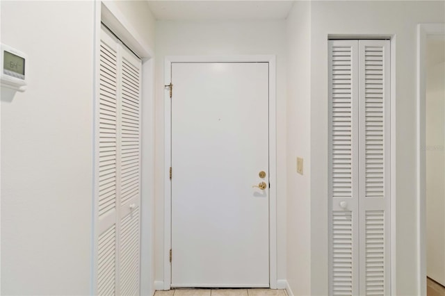 doorway to outside featuring light tile patterned flooring