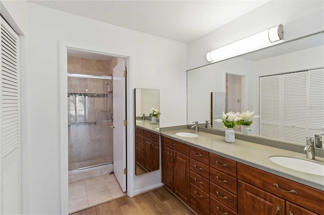 bathroom with vanity, a shower with door, and hardwood / wood-style floors