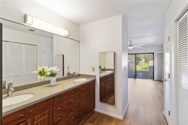 bathroom featuring vanity, hardwood / wood-style floors, and ceiling fan