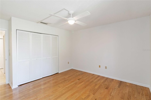 unfurnished bedroom with a closet, ceiling fan, and light wood-type flooring