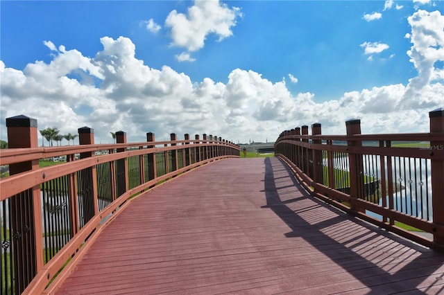 surrounding community featuring a deck with water view