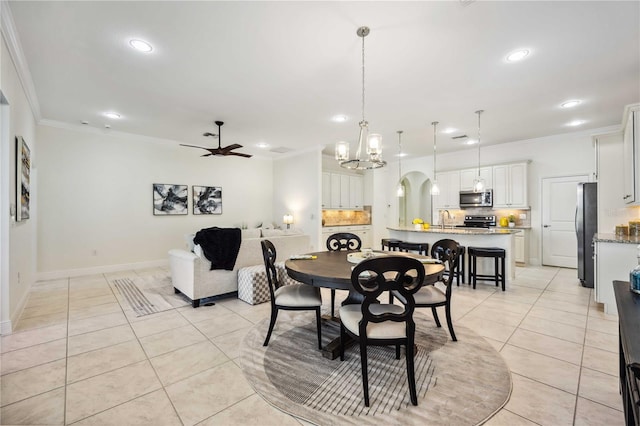 dining space featuring light tile patterned floors, arched walkways, a ceiling fan, crown molding, and recessed lighting