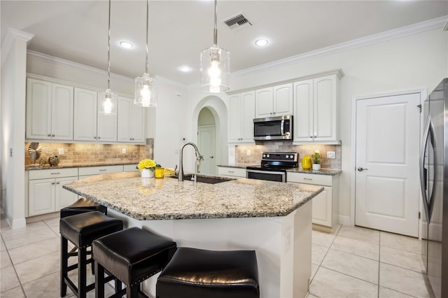 kitchen featuring arched walkways, stainless steel appliances, a sink, visible vents, and ornamental molding