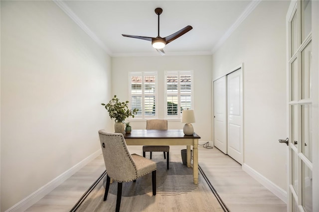 office with ornamental molding, light wood-style floors, baseboards, and a ceiling fan