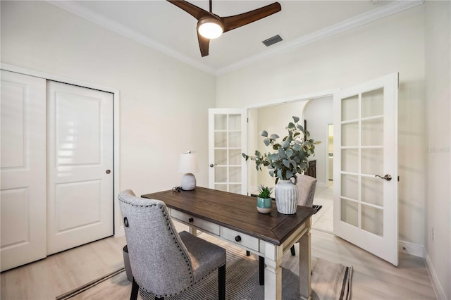 home office with light wood-type flooring, ceiling fan, crown molding, and french doors