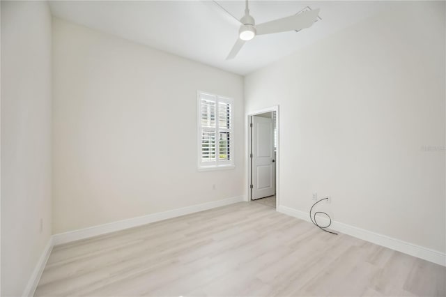 unfurnished room with baseboards, ceiling fan, and light wood-style floors