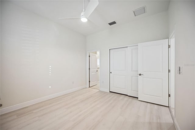 unfurnished bedroom with ceiling fan, visible vents, baseboards, a closet, and light wood-type flooring