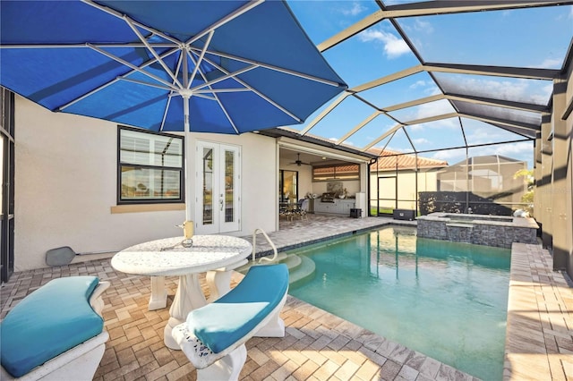 pool with a patio area, glass enclosure, an in ground hot tub, and french doors