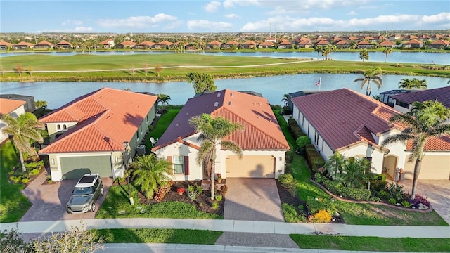 drone / aerial view featuring a residential view and a water view