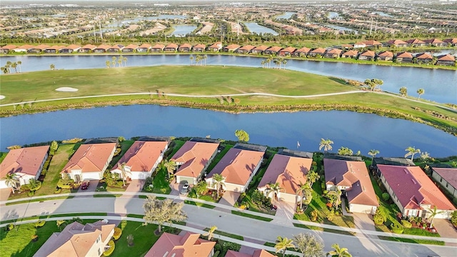 aerial view with view of golf course, a water view, and a residential view