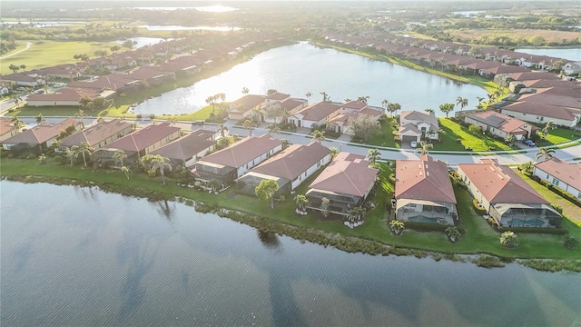 birds eye view of property with a water view and a residential view