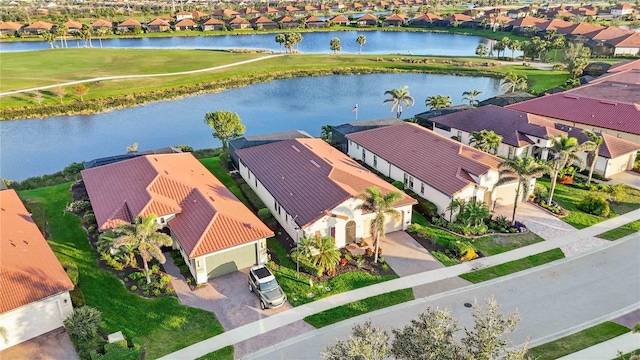 drone / aerial view with a water view and a residential view