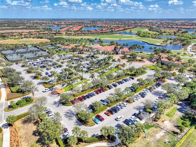 birds eye view of property featuring a water view and golf course view