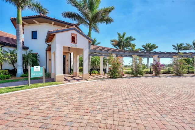 mediterranean / spanish-style house with a pergola and stucco siding