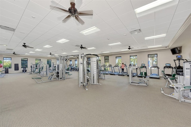 workout area with a ceiling fan, a paneled ceiling, and visible vents