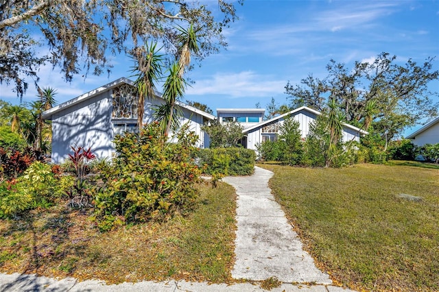 mid-century inspired home with a front lawn