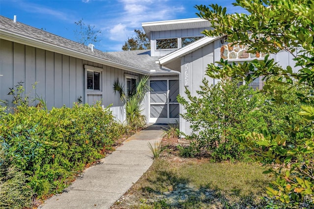 doorway to property featuring board and batten siding