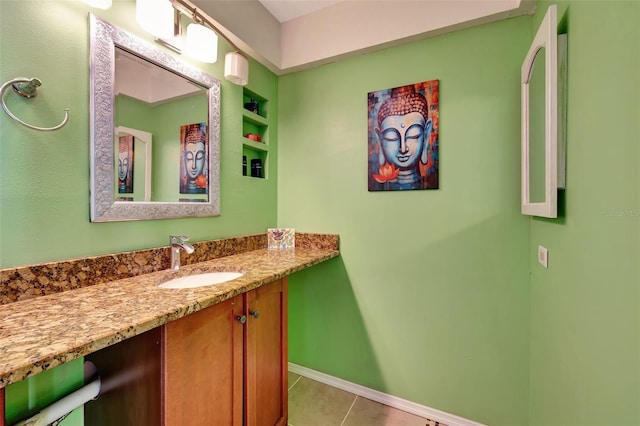 bathroom featuring tile patterned flooring, vanity, and baseboards