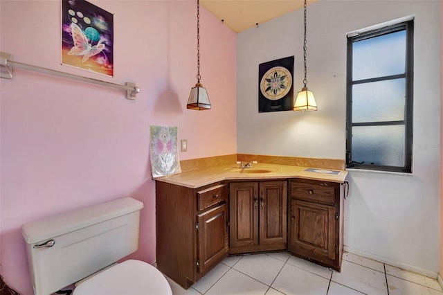 bathroom featuring vanity, tile patterned flooring, and toilet