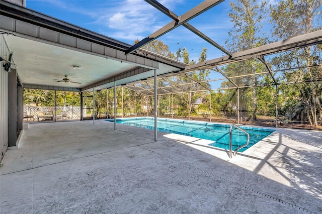 pool featuring a ceiling fan, glass enclosure, and a patio area