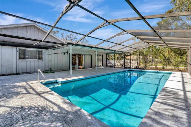 outdoor pool featuring a patio and glass enclosure