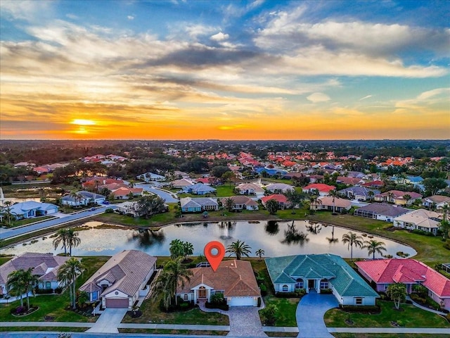 aerial view at dusk with a water view