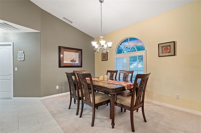 dining space with high vaulted ceiling, light tile patterned floors, and an inviting chandelier