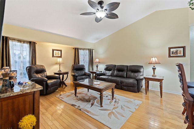 living room featuring ceiling fan, lofted ceiling, and light hardwood / wood-style floors