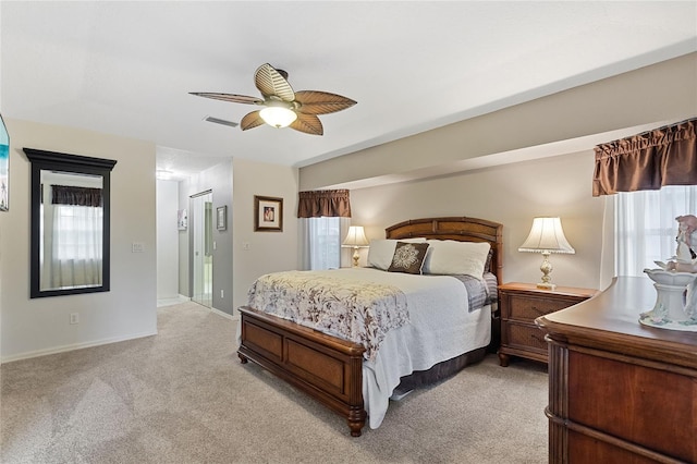 bedroom with multiple windows, light colored carpet, and ceiling fan