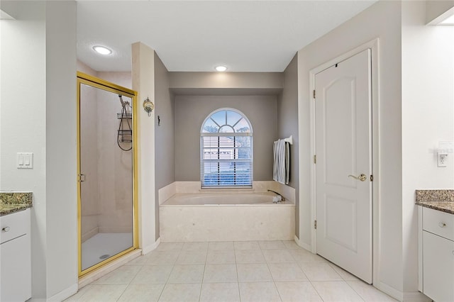 bathroom featuring tile patterned floors, vanity, and separate shower and tub