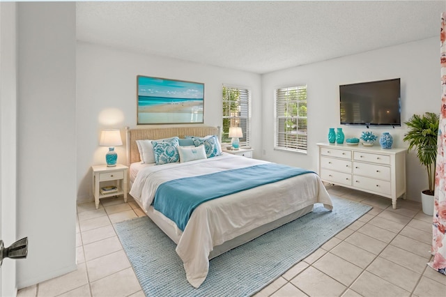 bedroom with a textured ceiling and light tile patterned flooring