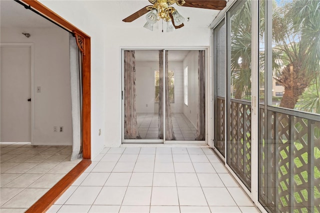 unfurnished sunroom featuring ceiling fan