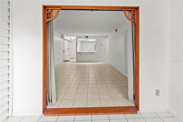 corridor featuring light tile patterned flooring