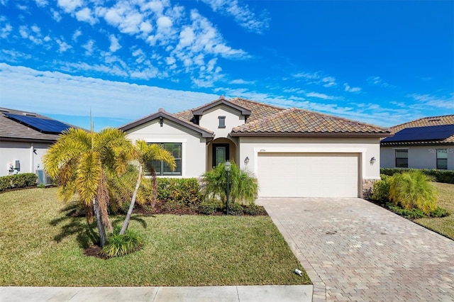 view of front of home featuring a garage and a front lawn