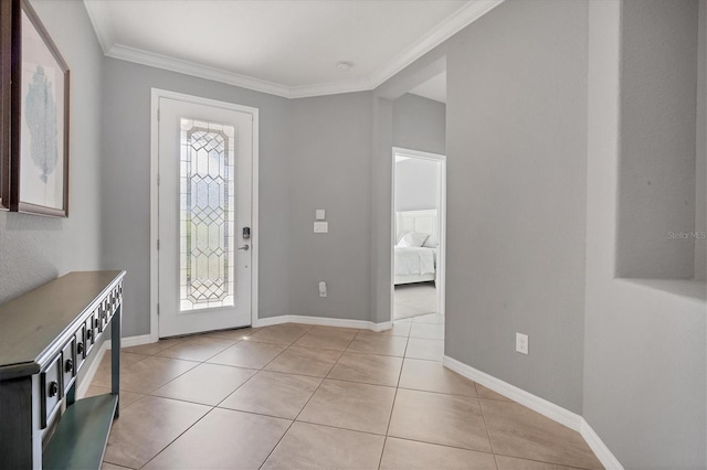 entrance foyer with light tile patterned flooring and ornamental molding