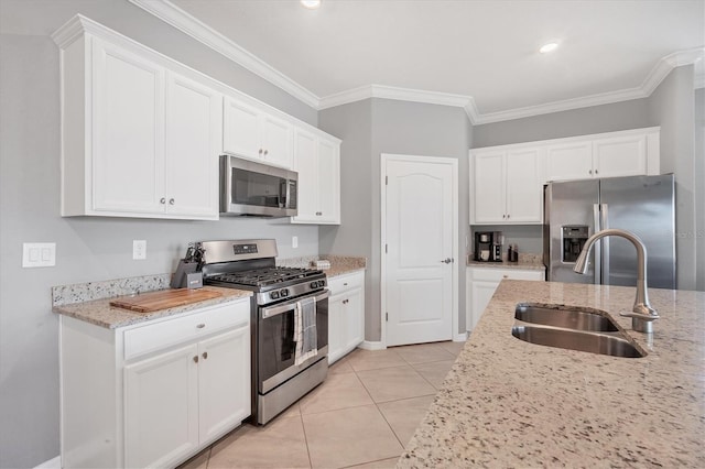 kitchen with stainless steel appliances, light stone countertops, sink, and light tile patterned floors