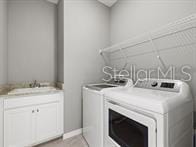 laundry area featuring independent washer and dryer and sink