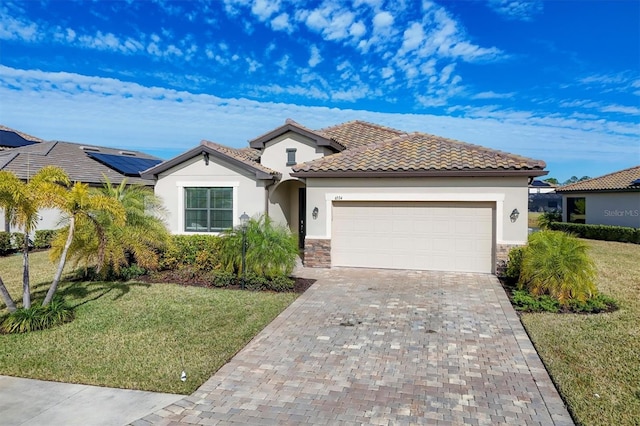 mediterranean / spanish-style home with a garage, a front yard, and solar panels