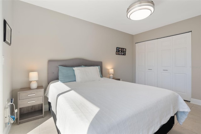 tiled bedroom with a closet