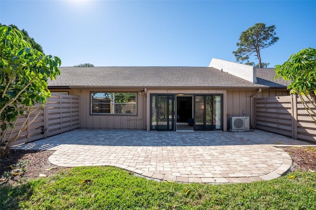 rear view of property with ac unit and a patio area