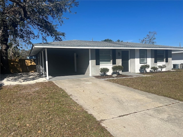 ranch-style house with central AC unit, a front lawn, and a carport