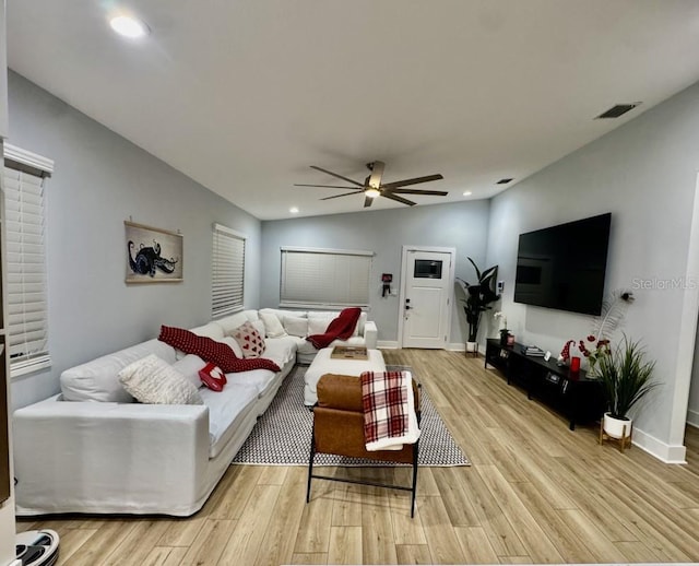 living room with vaulted ceiling, ceiling fan, and light hardwood / wood-style floors