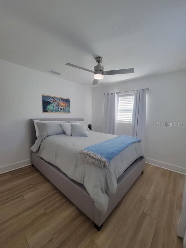 bedroom featuring ceiling fan and light hardwood / wood-style floors