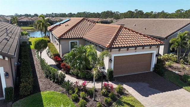 5337 Popoli Way, Sarasota, FL 34238 - mediterranean / spanish home featuring a water view and a garage